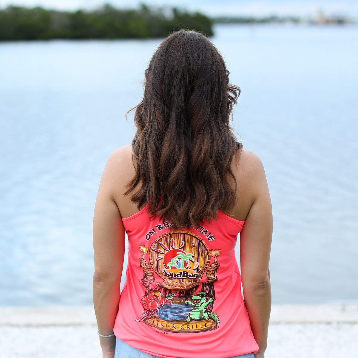 Sandbar Tiki & Grille Women's Racerback Tank Top in Hot Coral - showing the logo on the back