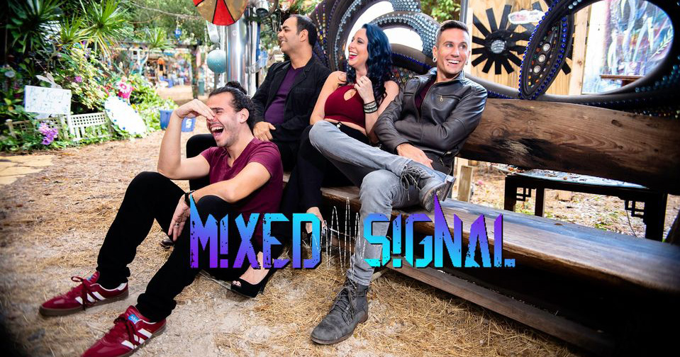 the four members of the band Mixed Signal sitting on a bench
